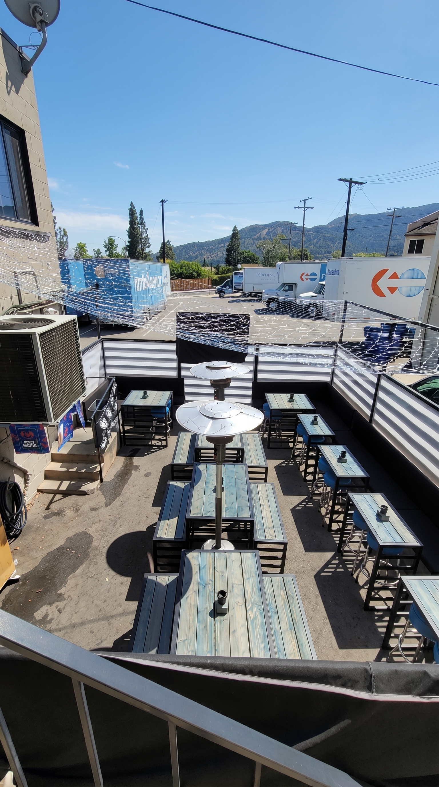 The patio at The Blue Moon, picnic tables and the Crescenta Valley behind